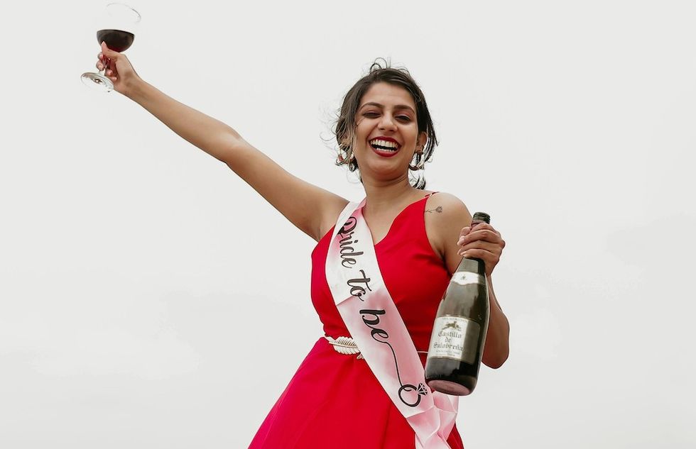 bride drinking wine at her bachelorette party