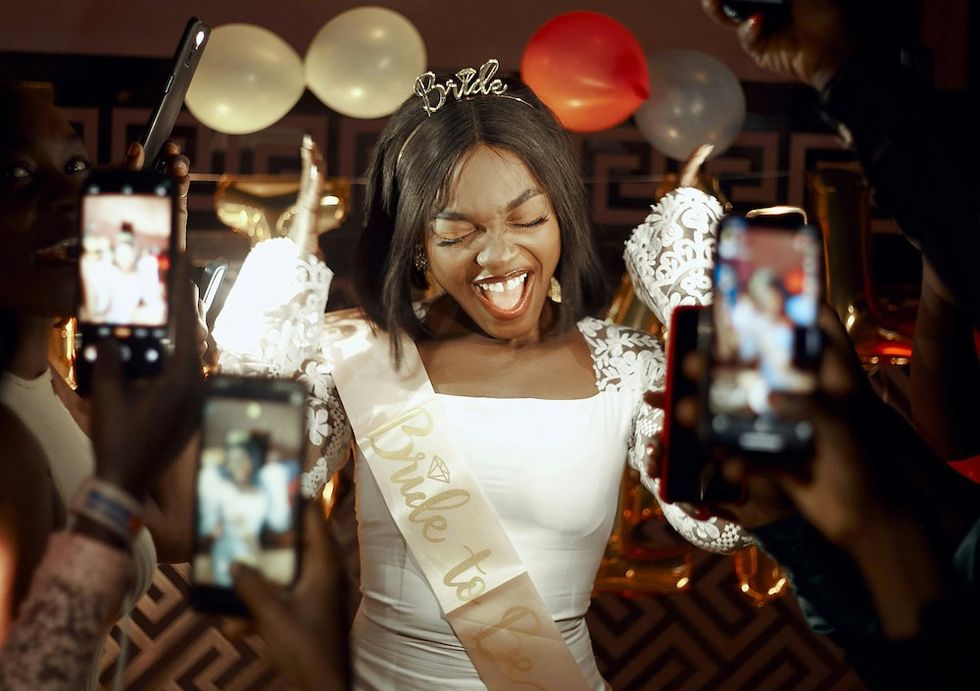 bride wearing a sash and a tiara at her bachelorette party