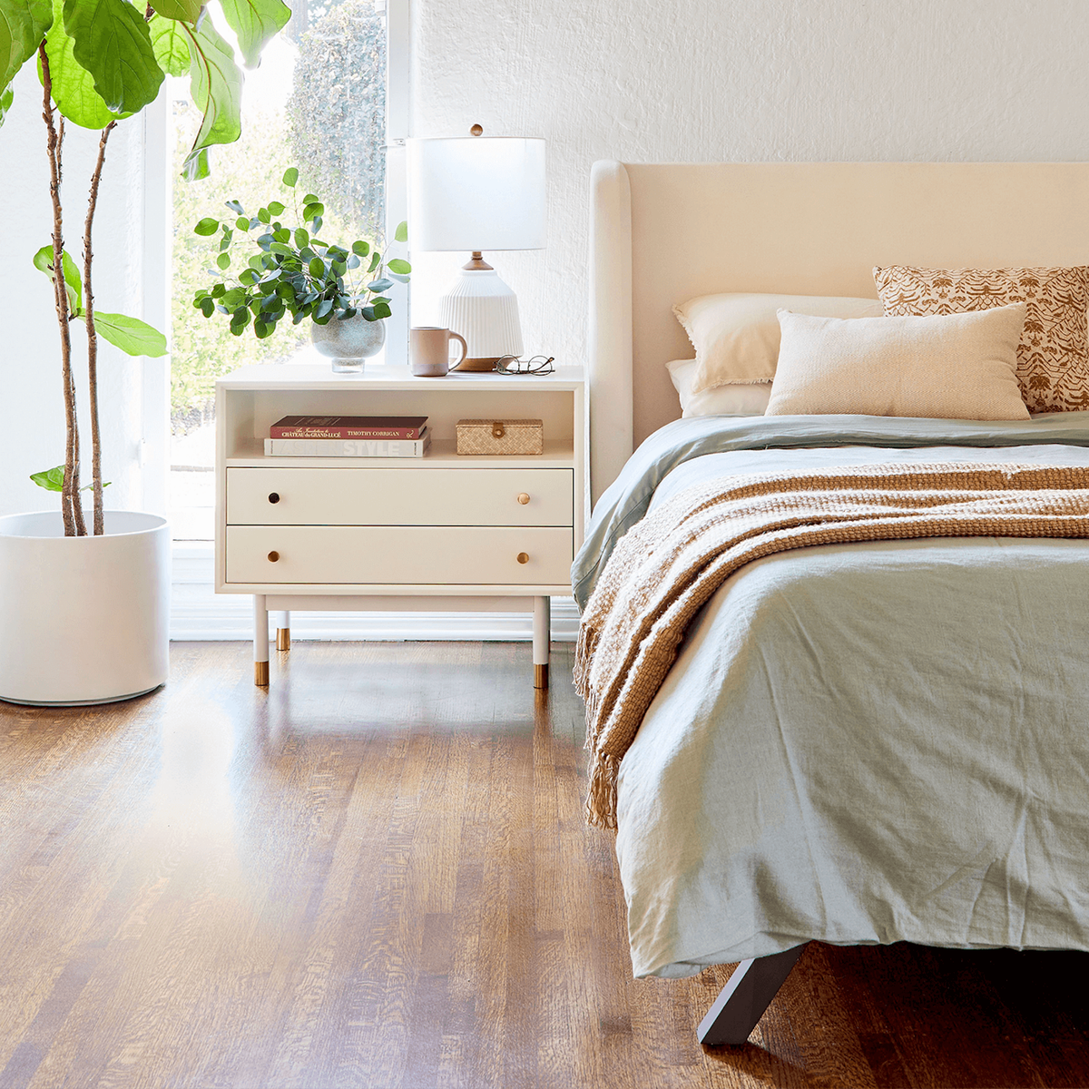 bright and airy room with a cream headboard from apt2b