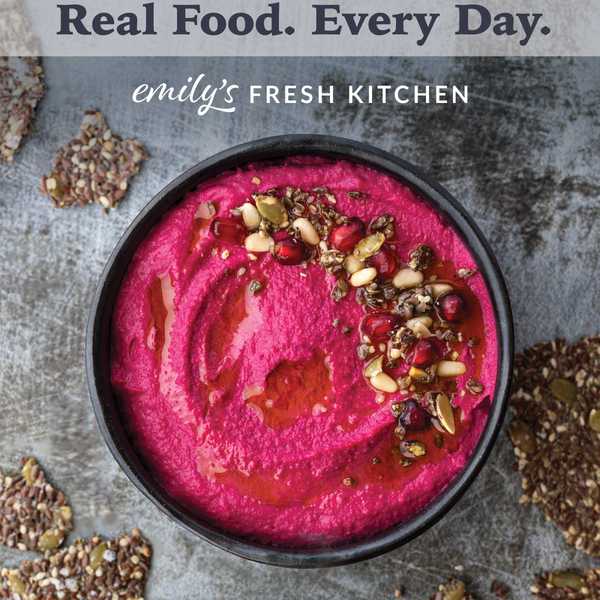 Bright pink dip with seeds and nuts, surrounded by crunchy crackers.