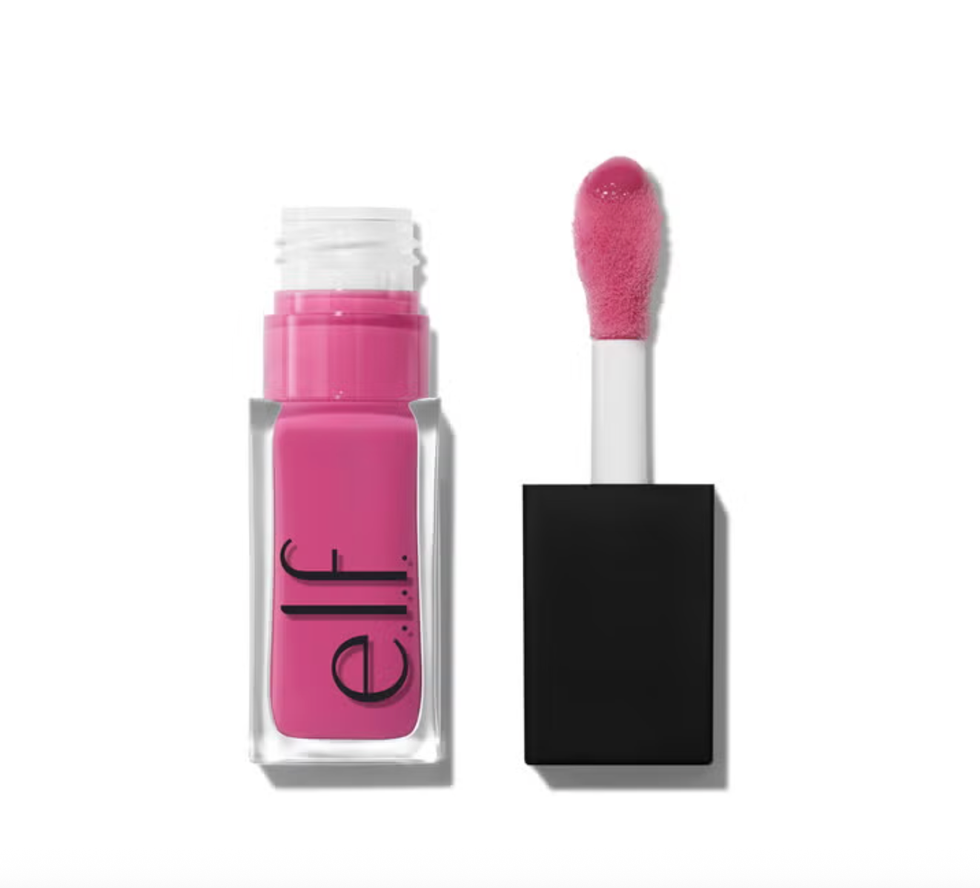Bright pink lip gloss with black lid and applicator wand on white background.