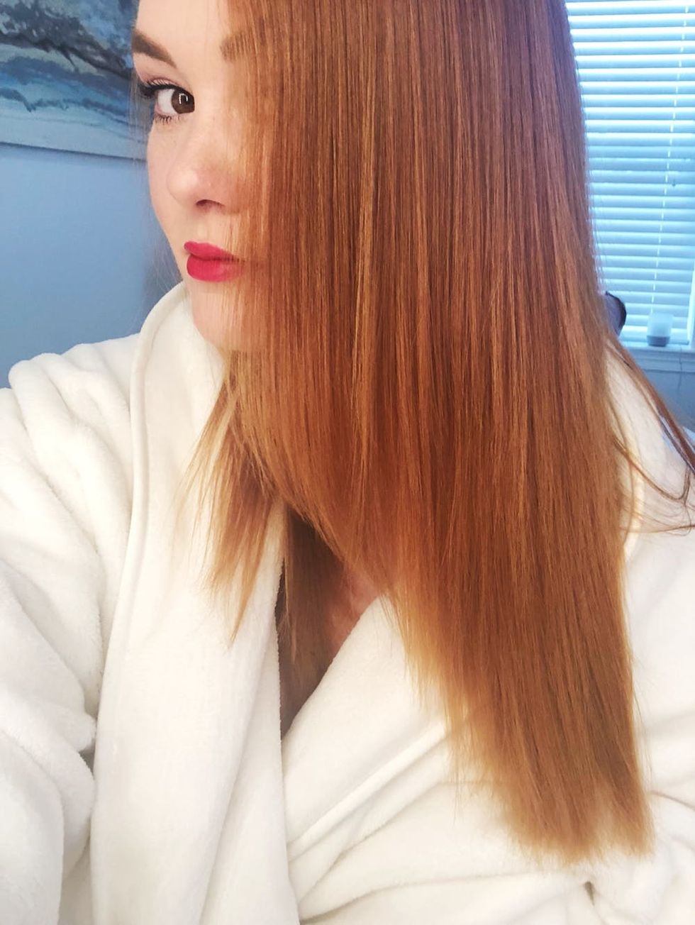 Brit + Co beauty editor, Rebecca Norris, showing off straight strands after styling with the ghd Platinum+