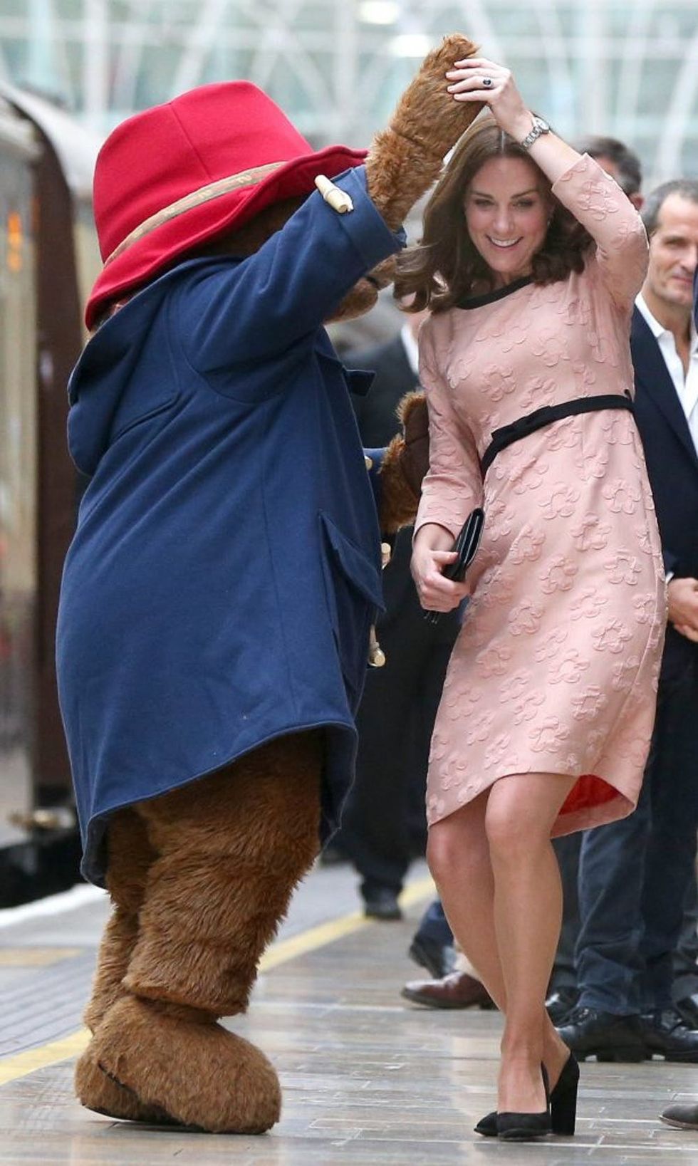 Britain's Catherine, Duchess of Cambridge dances with a person in a Paddington Bear as she attends a charities forum event at Paddington train station in London on October 16, 2017. The Duke and Duchess of Cambridge and Prince Harry joined children from the charities they support on board Belmond British Pullman train at Paddington Station. / AFP PHOTO / POOL / Jonathan Brady (Photo credit should read JONATHAN BRADY/AFP/Getty Images)