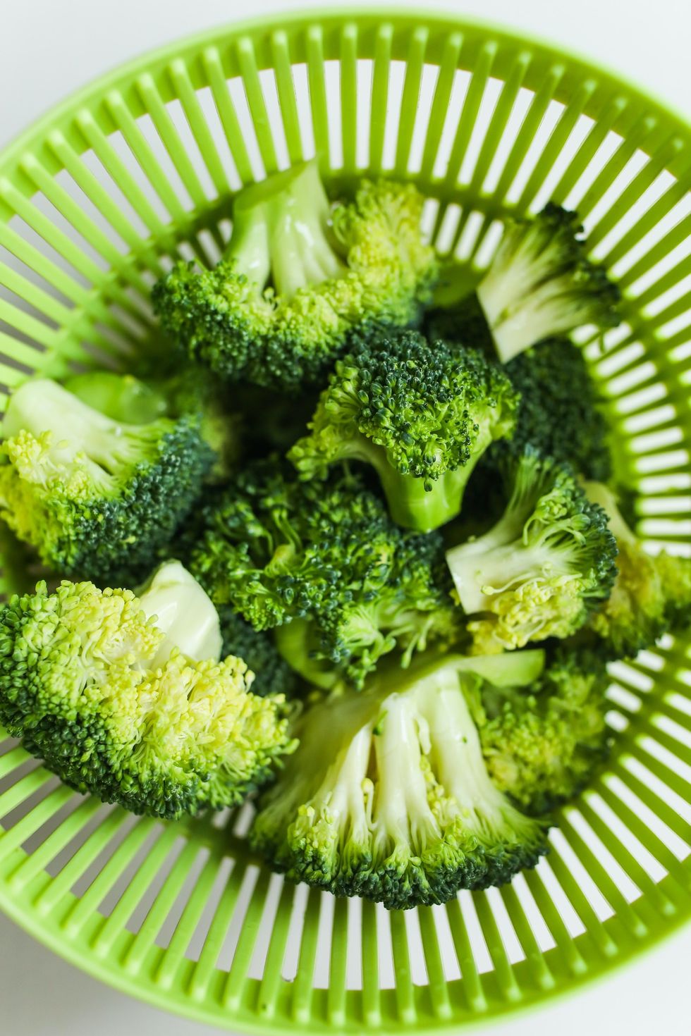 broccoli stems in a green bowl