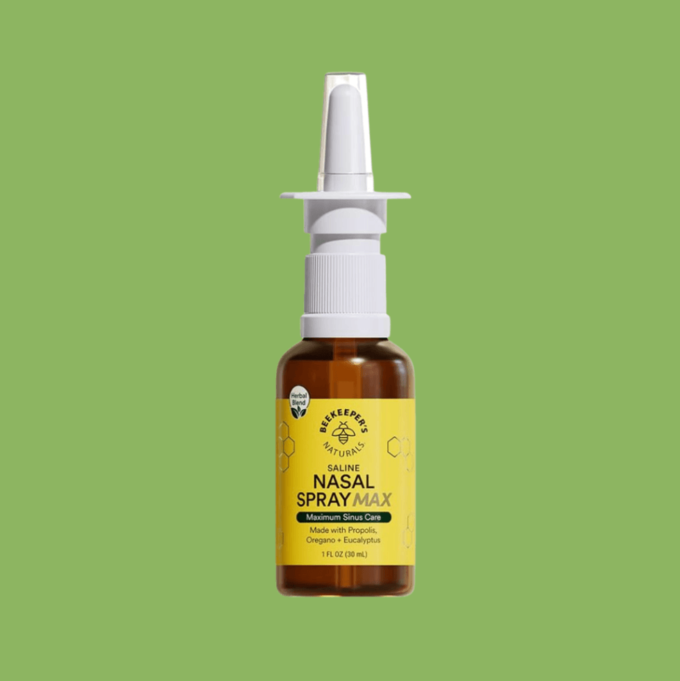 Brown nasal spray bottle with a yellow label on a green background.