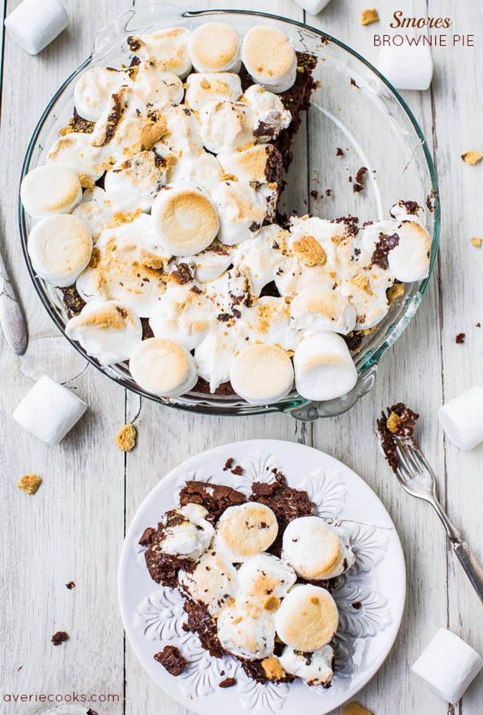 brownie pie with marshmallows on a white plate and a wooden table