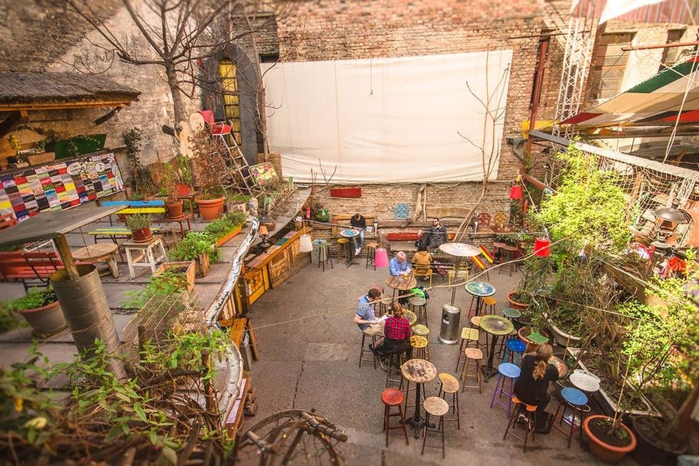 Budapest, Hungary - Mars 31, 2016: Outdoor terrace of one of the most attractive and touristic ruin pubs, the Szimpla, at Kazinczy street. Ruin pubs, most in District VII, former Jewish quarter, are a trend of Budapest cultural and night life.