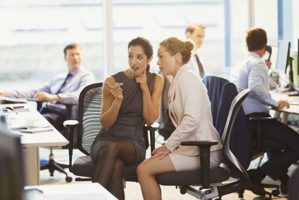 Businesswomen gossiping in office