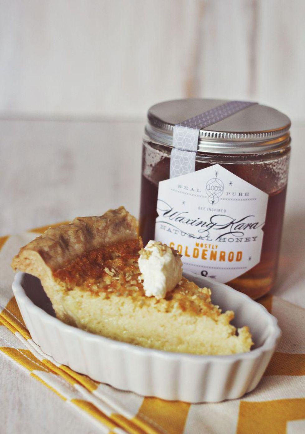 buttermilk and honey pie with a dollop of cream sitting in a creme br\u00fbl\u00e9e dish