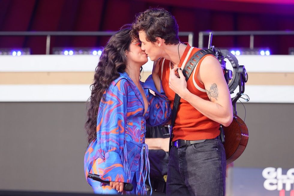 camila cabello and shawn mendes share a kiss while onstage