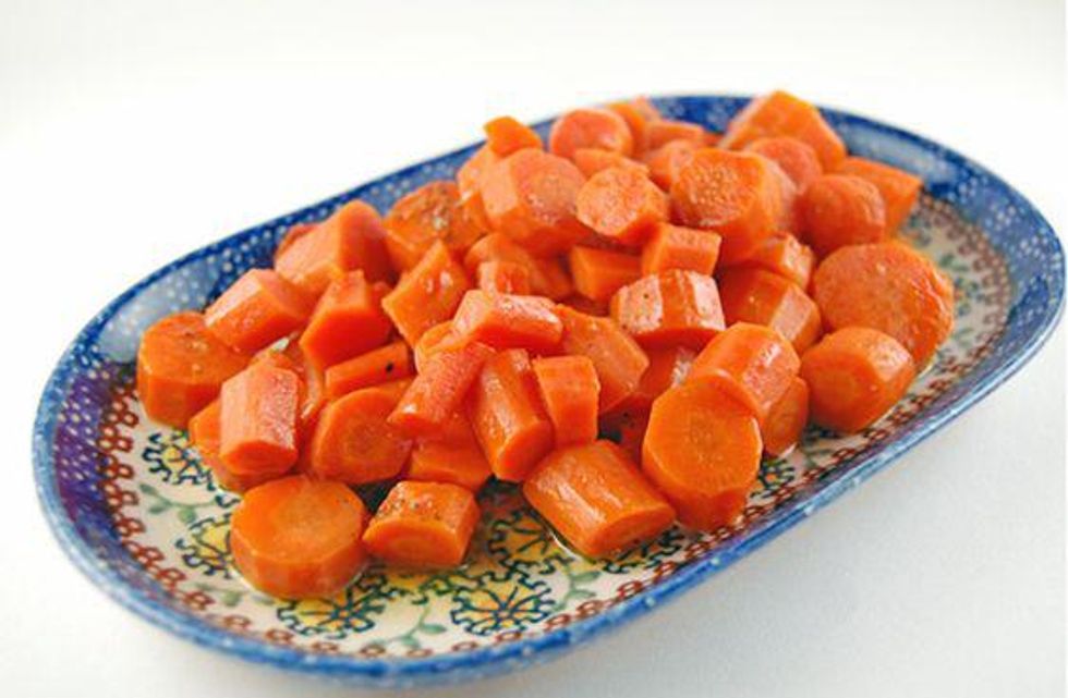 carrots on a blue tray with a honey glaze