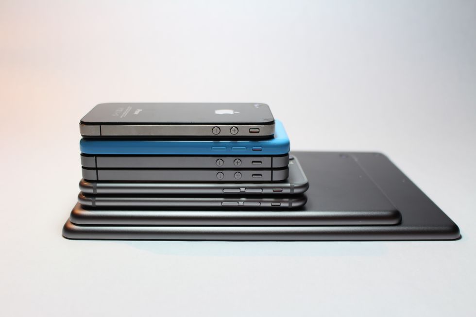 cell phones, ipad and laptop pile