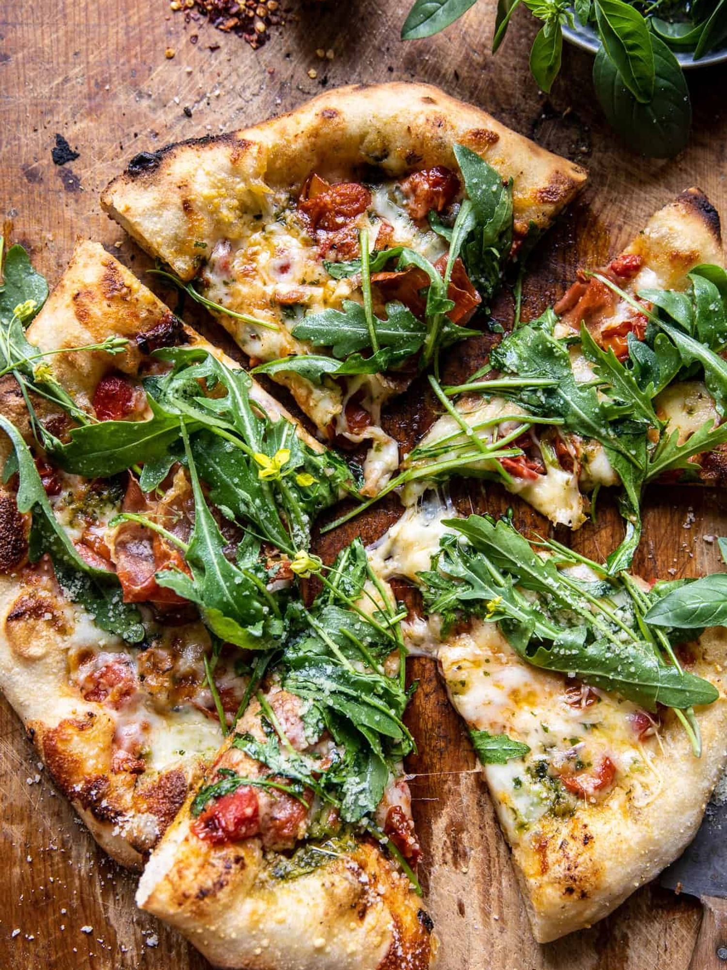 Cheese pizza topped with Arugula and Tomatoes