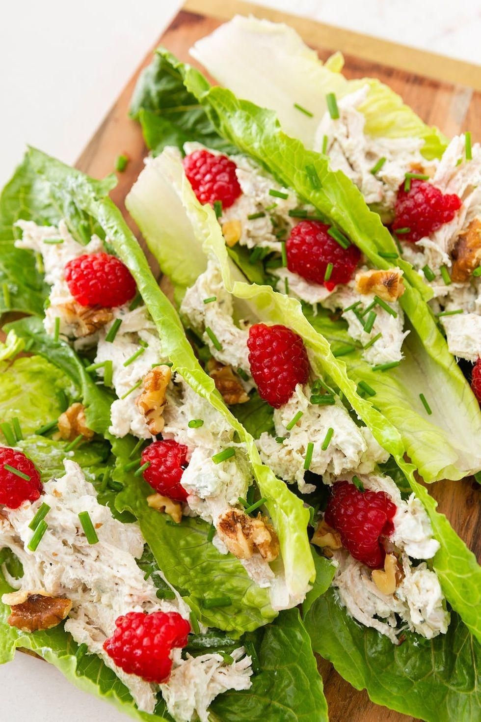chicken salad wrapped in lettuce with nuts and raspberries