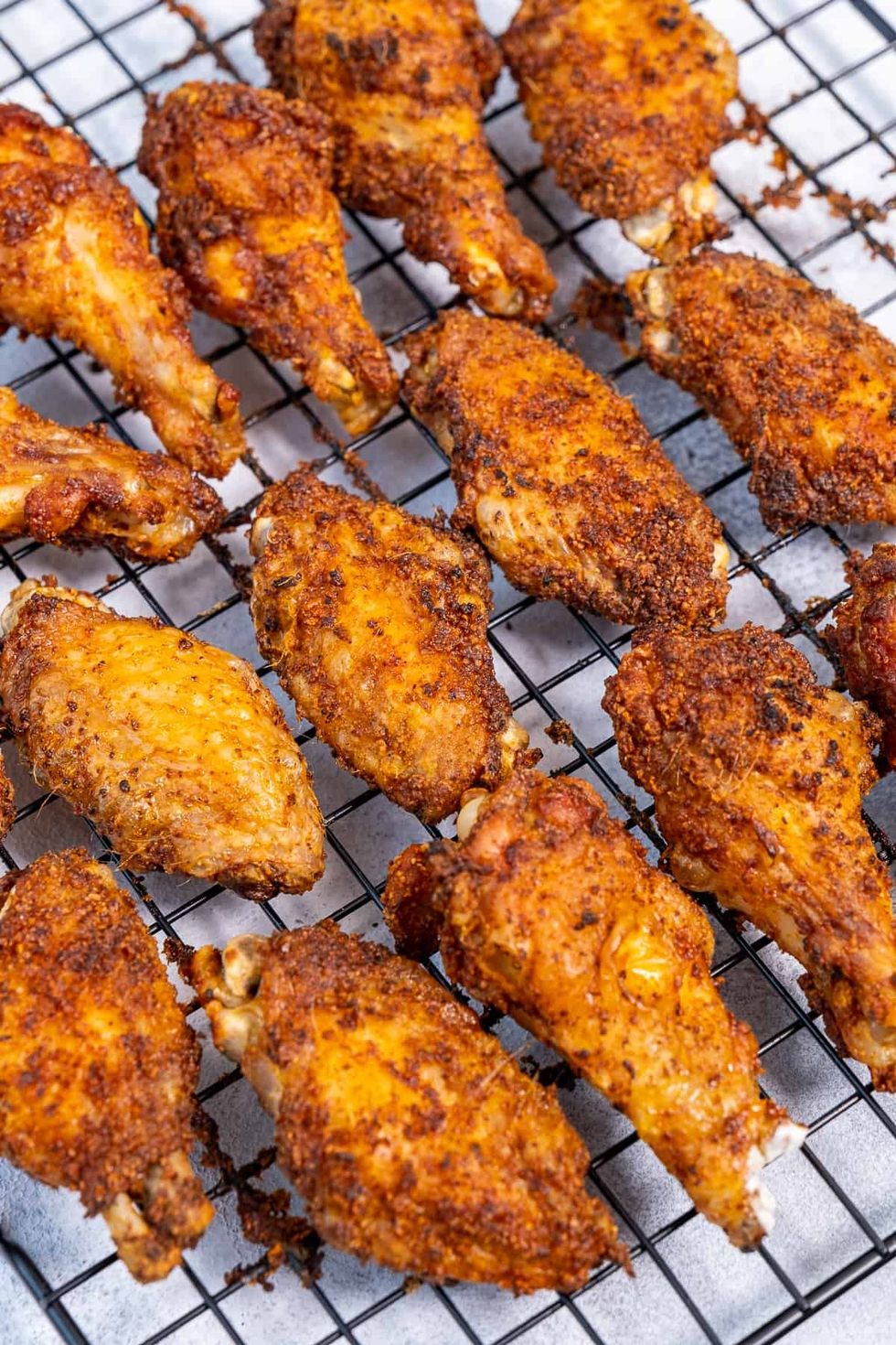 Chicken wings sit on a rack.