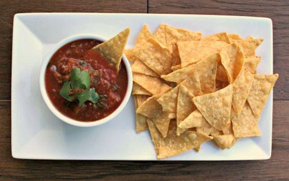 chips with slow cooker salsa on a white plate