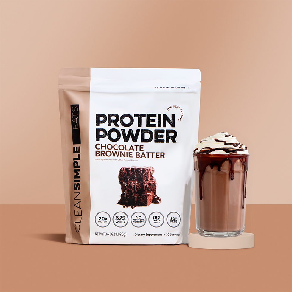 Chocolate brownie protein powder with a chocolate smoothie topped with whipped cream.