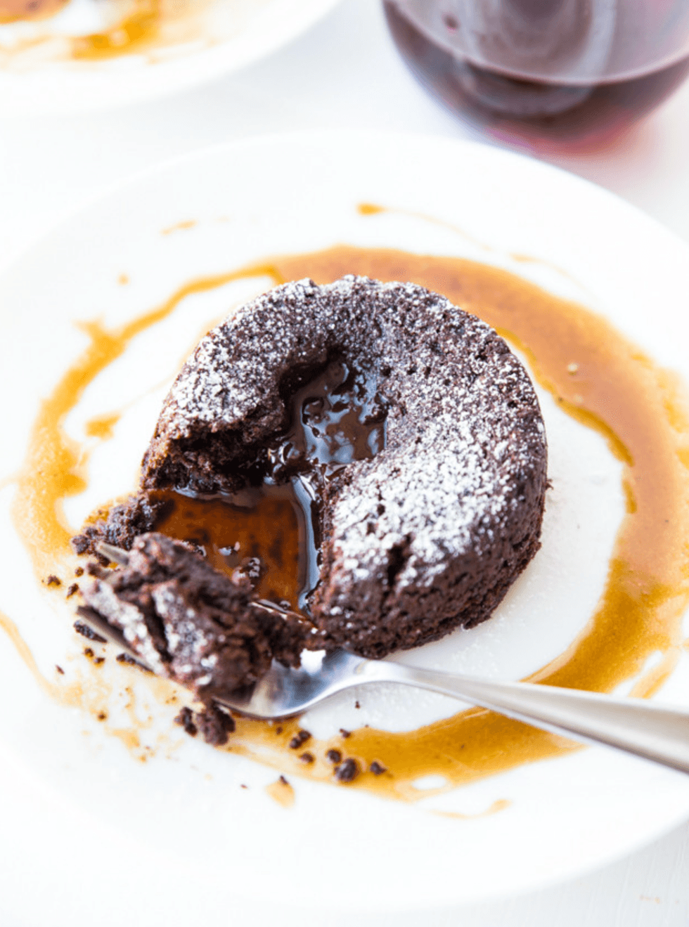 Chocolate lava cake with molten center on a white plate.