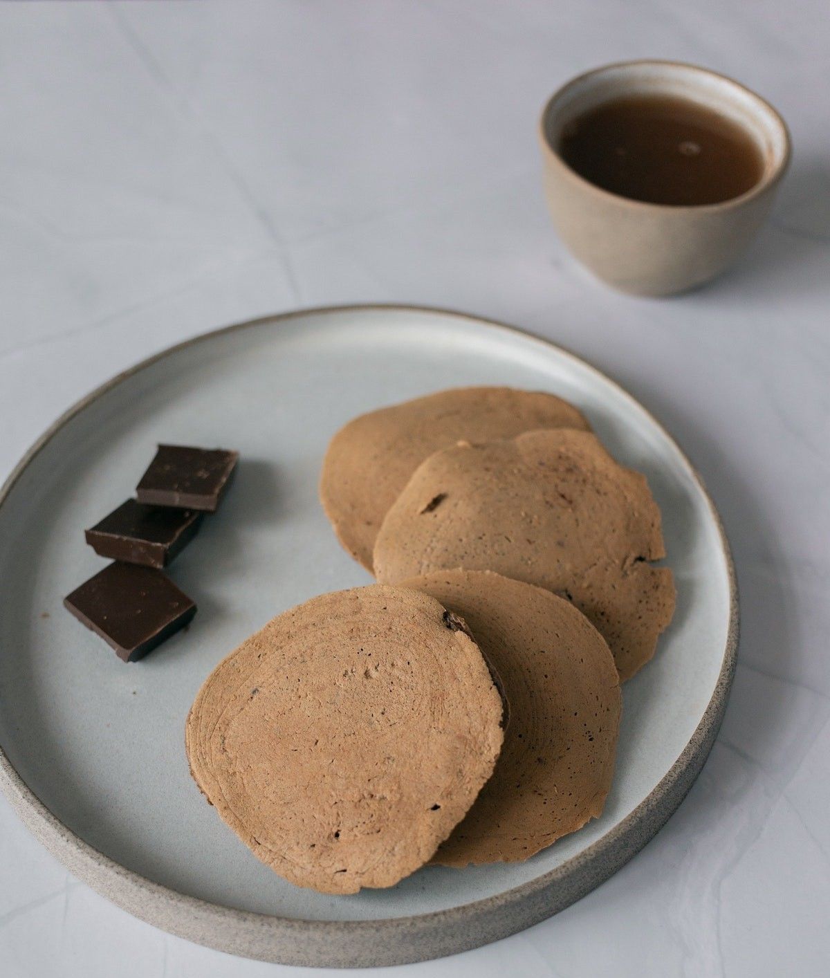 Chocolate pancakes on ceramic plate
