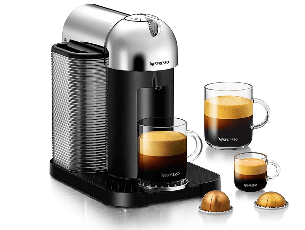 Chrome Nespresso machine with two coffee mugs, one espresso cup, and two coffee pods.
