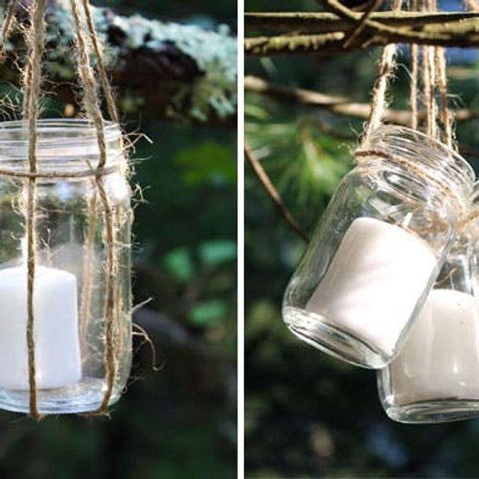clear mason jars with white candles inside