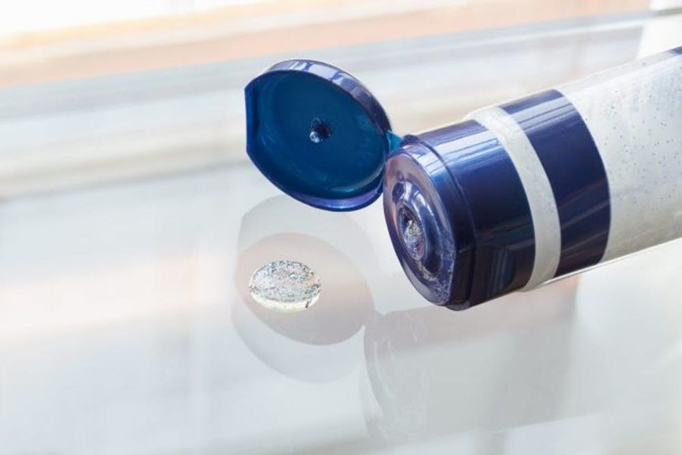 Closeup of facewash scrub with microbeads on glass surface
