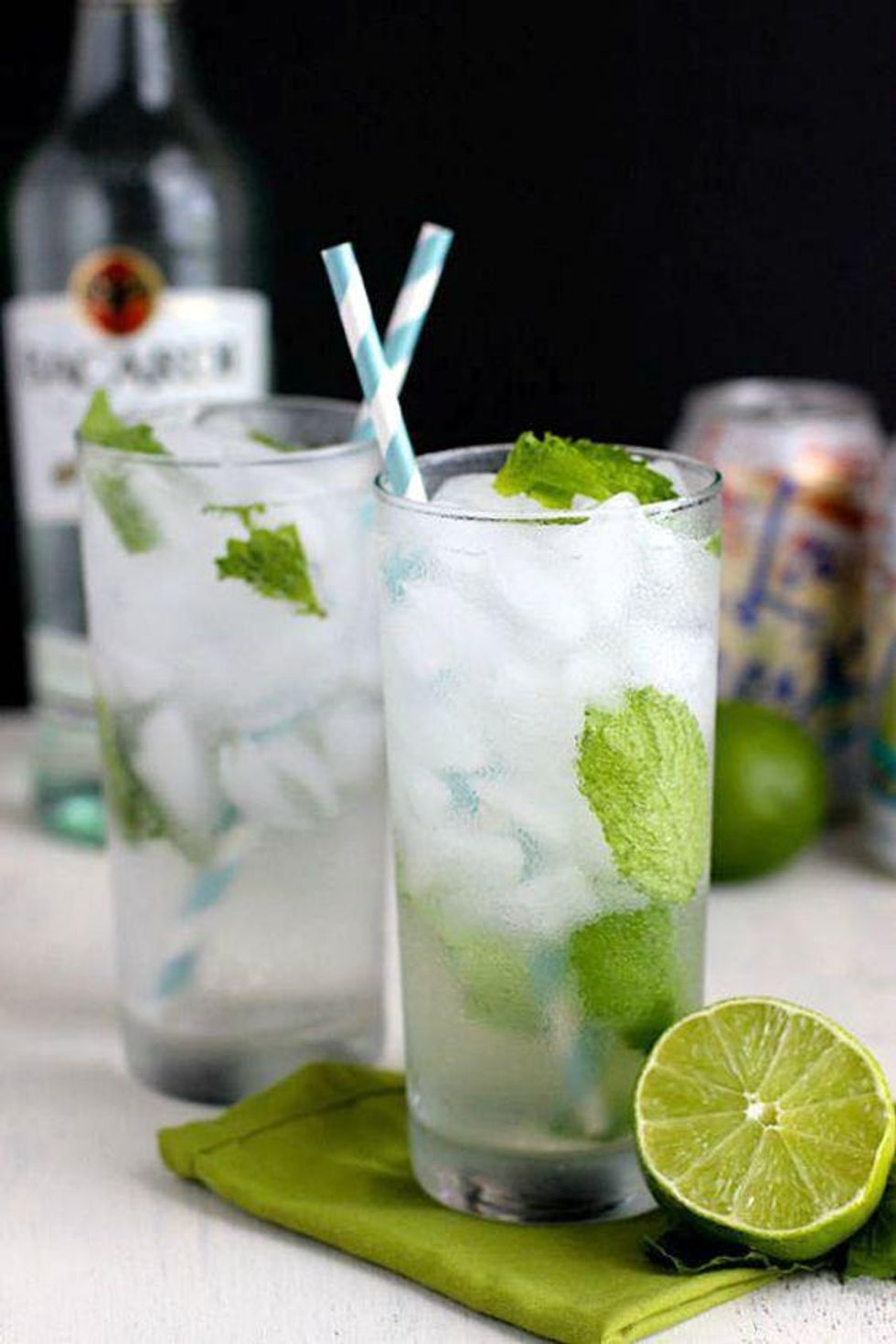 Coconut Mojitos with mint and lime sitting on a green napkin