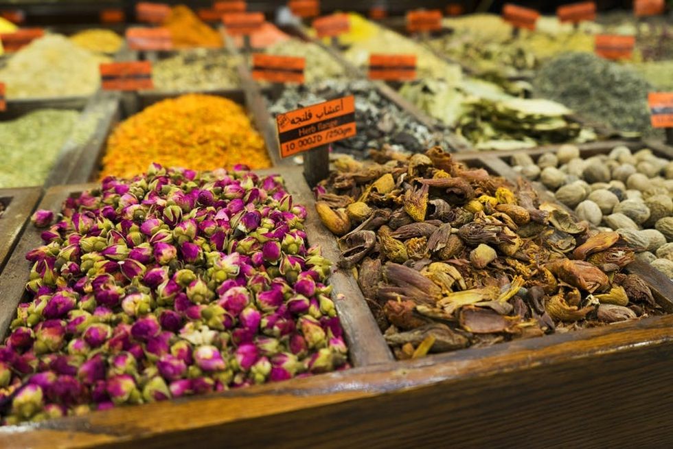 Colorful dried flowers are presented for sale at a spice market in Amman