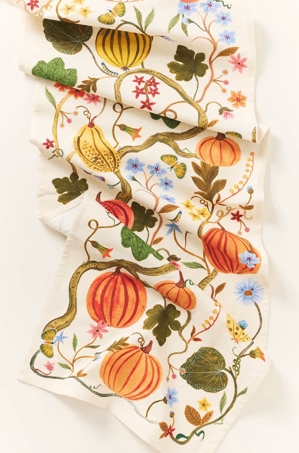 Colorful runner with pumpkins, flowers, and leaves in a botanical design.