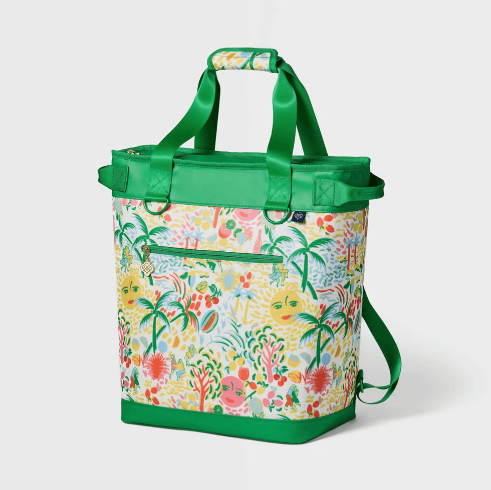 Colorful tropical print bag with green straps and trim.