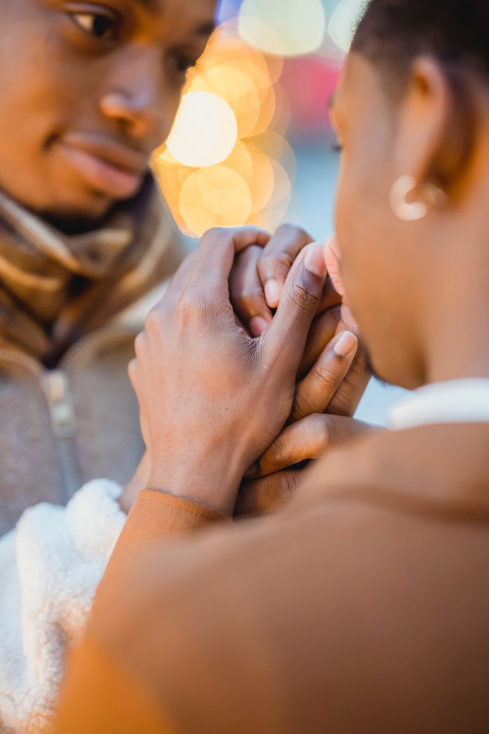 couple close-up holding hands