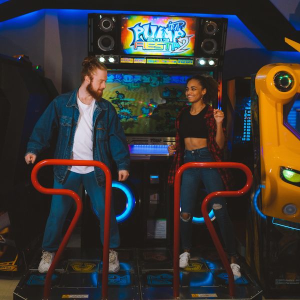 couple dancing on an arcade game date ideas