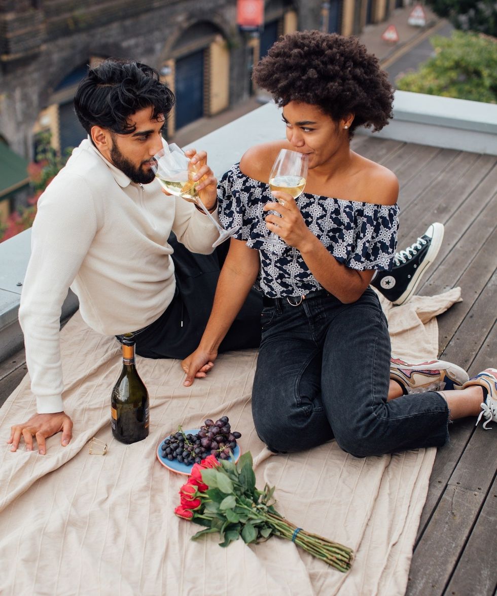 couple drinking wine on a rooftop