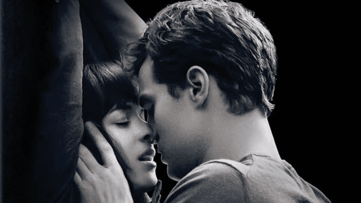 Couple embracing intimately beneath the "Fifty Shades of Grey" title.