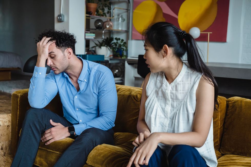 couple have a discussion on their sofa