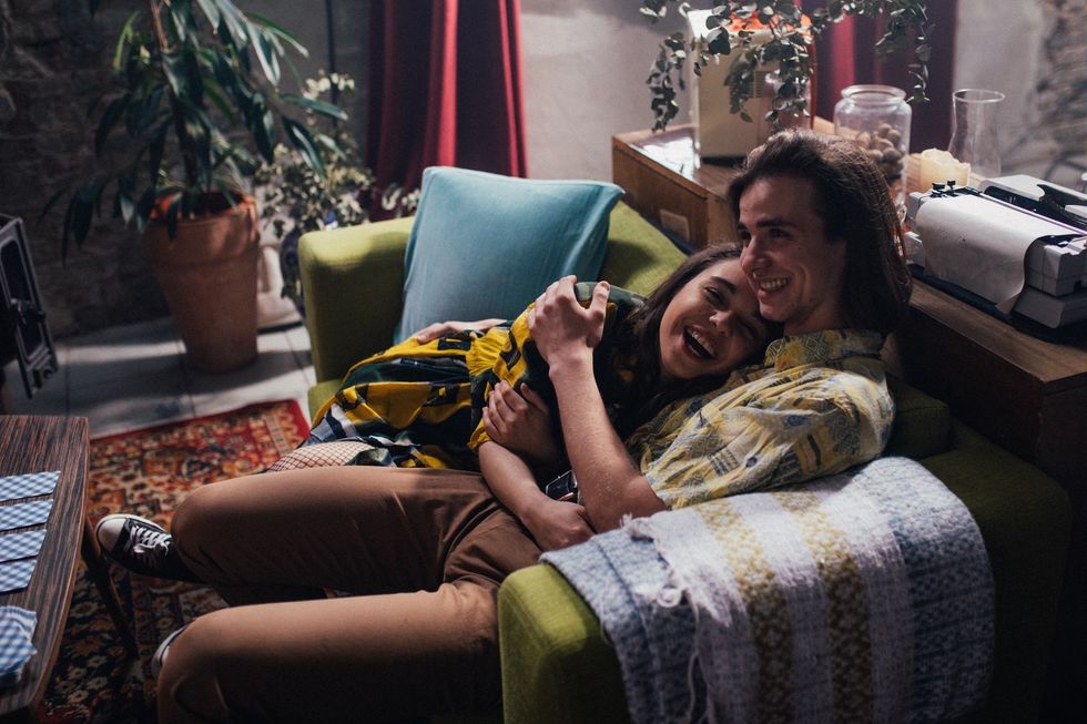 Couple holding each other on couch