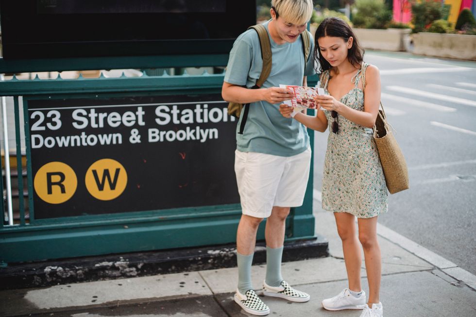 couple in new york reading maps to travel