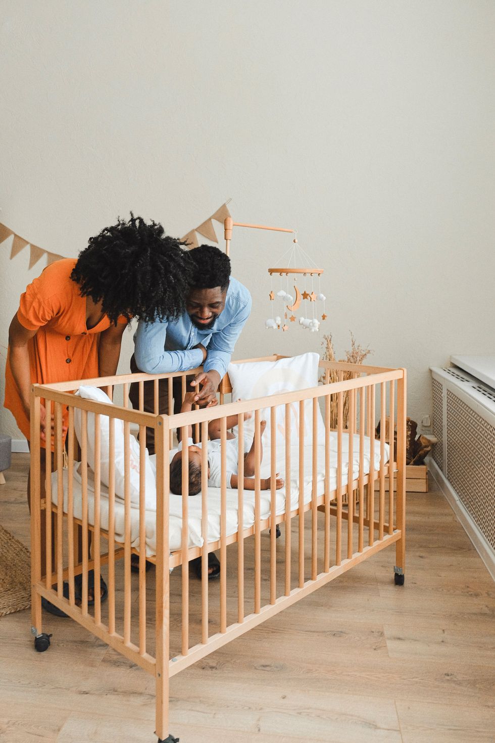 couple looking at infant in crib