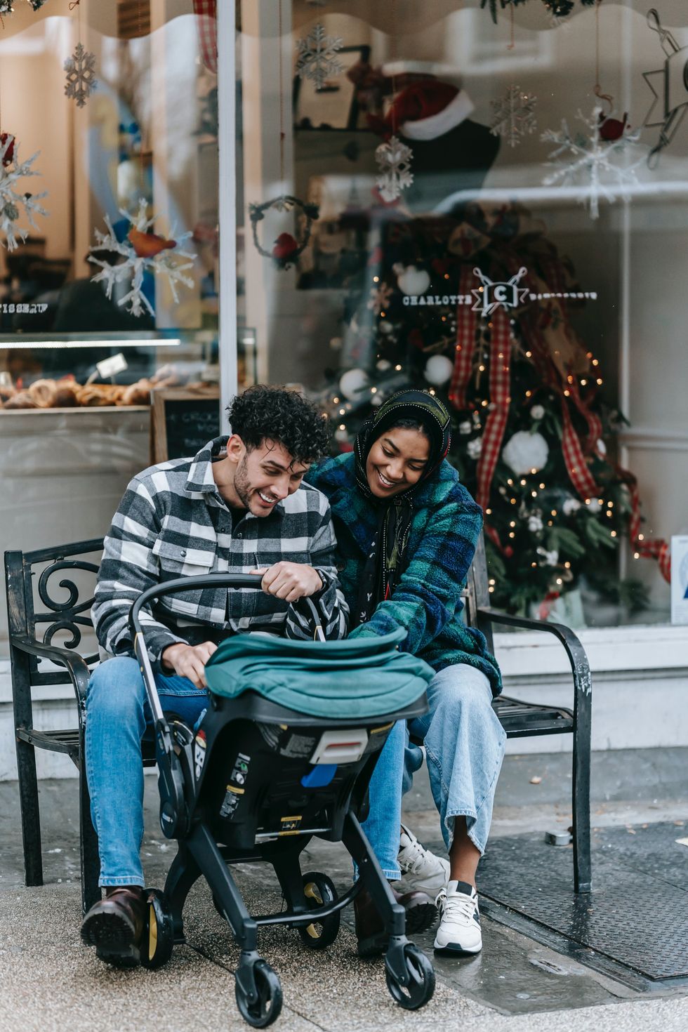 couple looking at their baby in stroller
