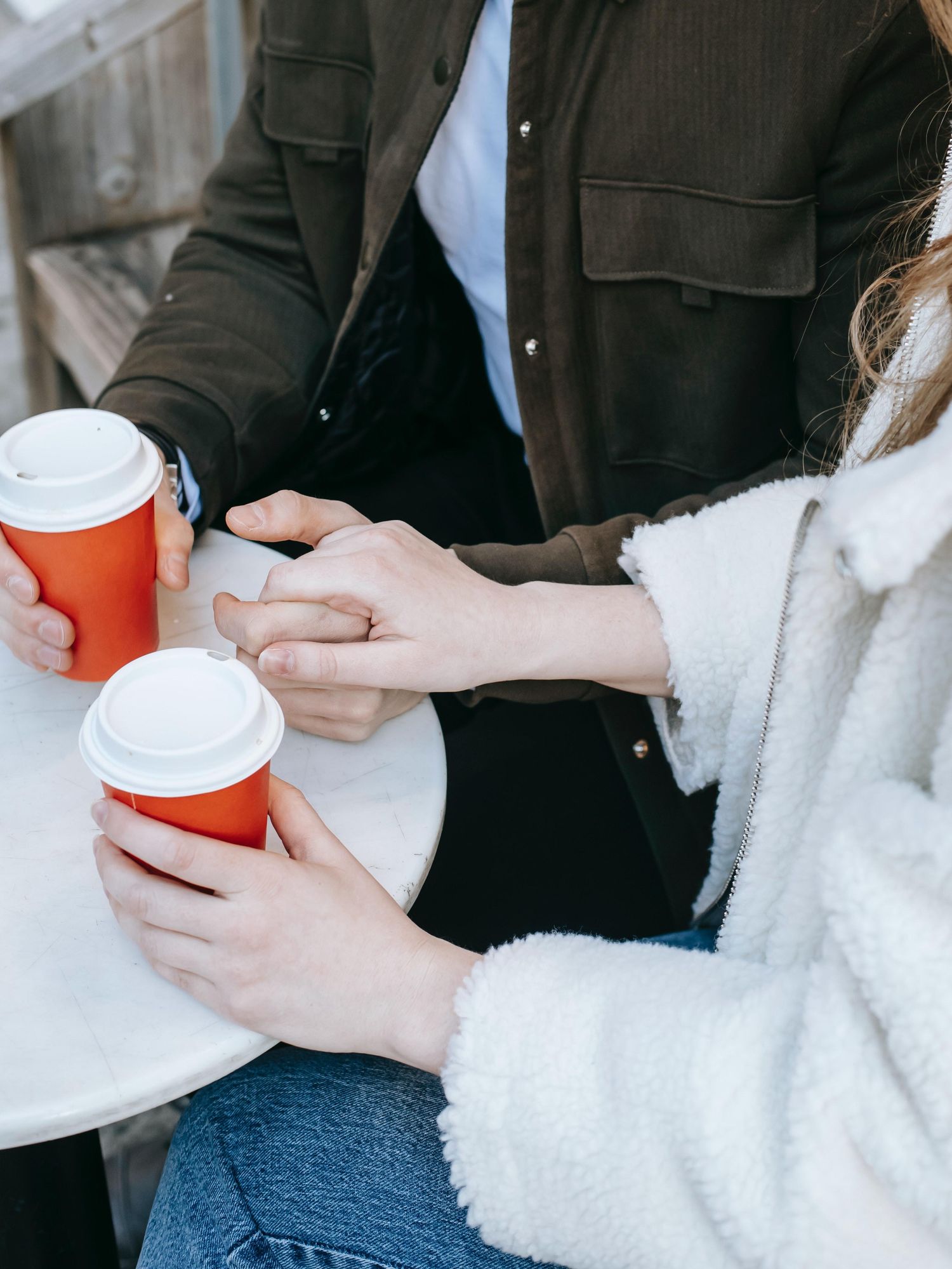 couple on a coffee date holding hands date night ideas