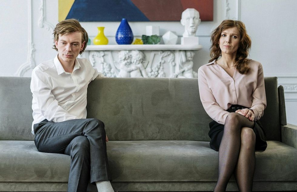 couple sitting awkwardly on the couch
