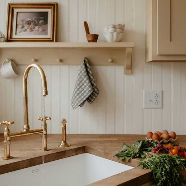Cozy kitchen corner with running faucet, fresh produce, and retro toaster.
