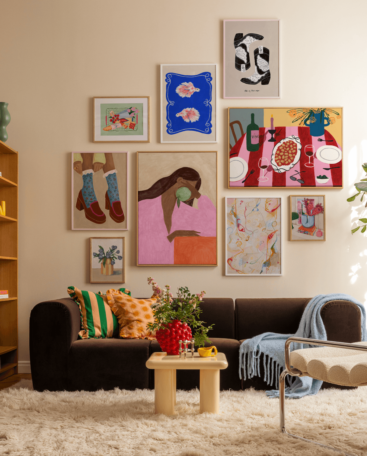 Cozy living room with colorful artwork, dark sofa, and light wooden table on a fluffy rug.