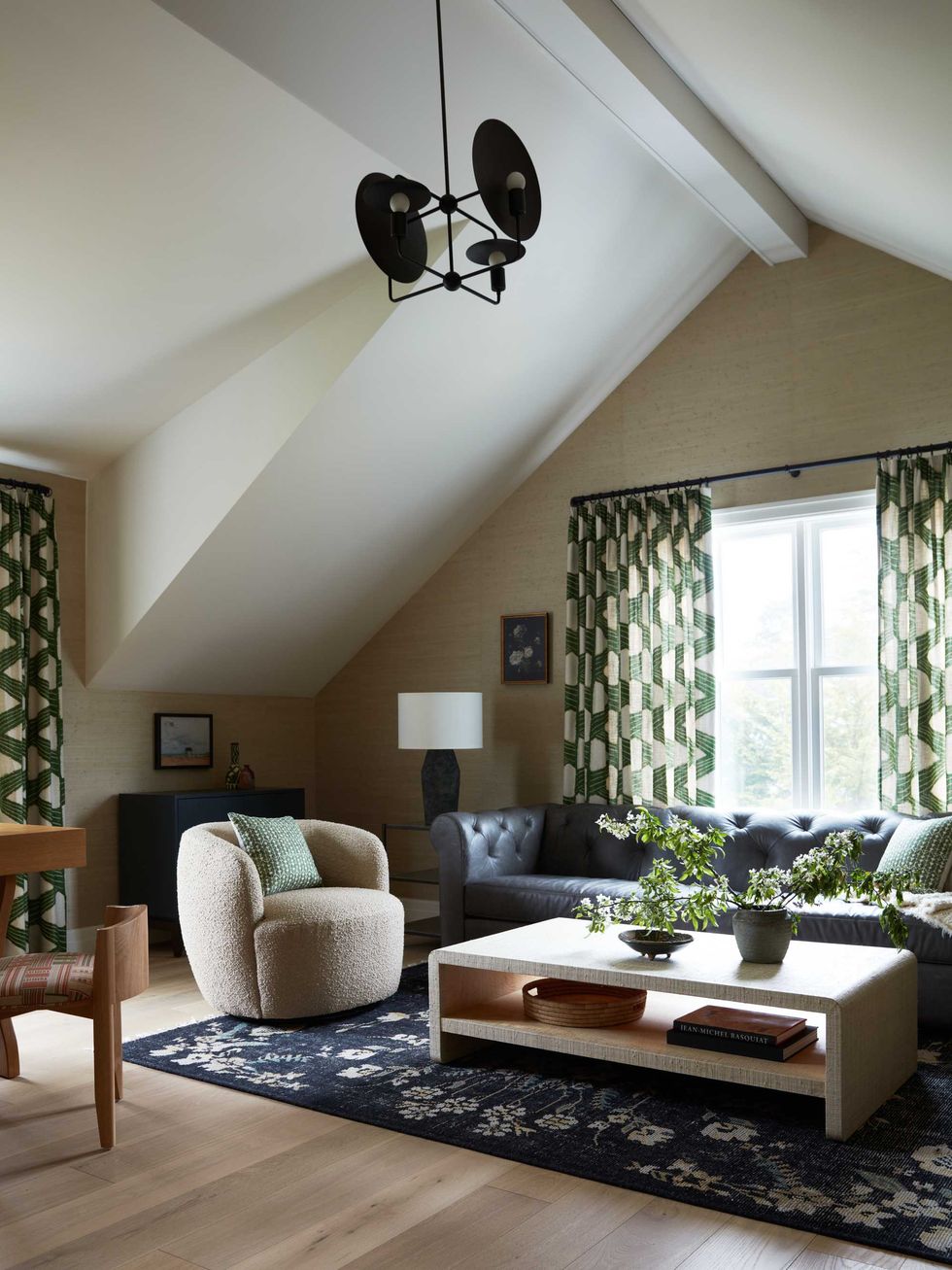 Cozy living room with modern lighting, patterned curtains, and a textured rug.