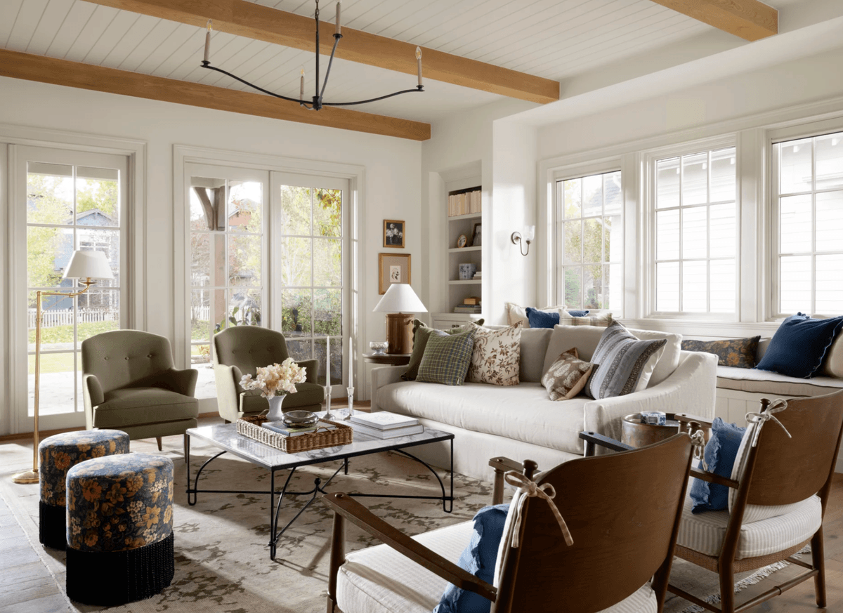 Cozy living room with neutral tones, large windows, and stylish furniture.