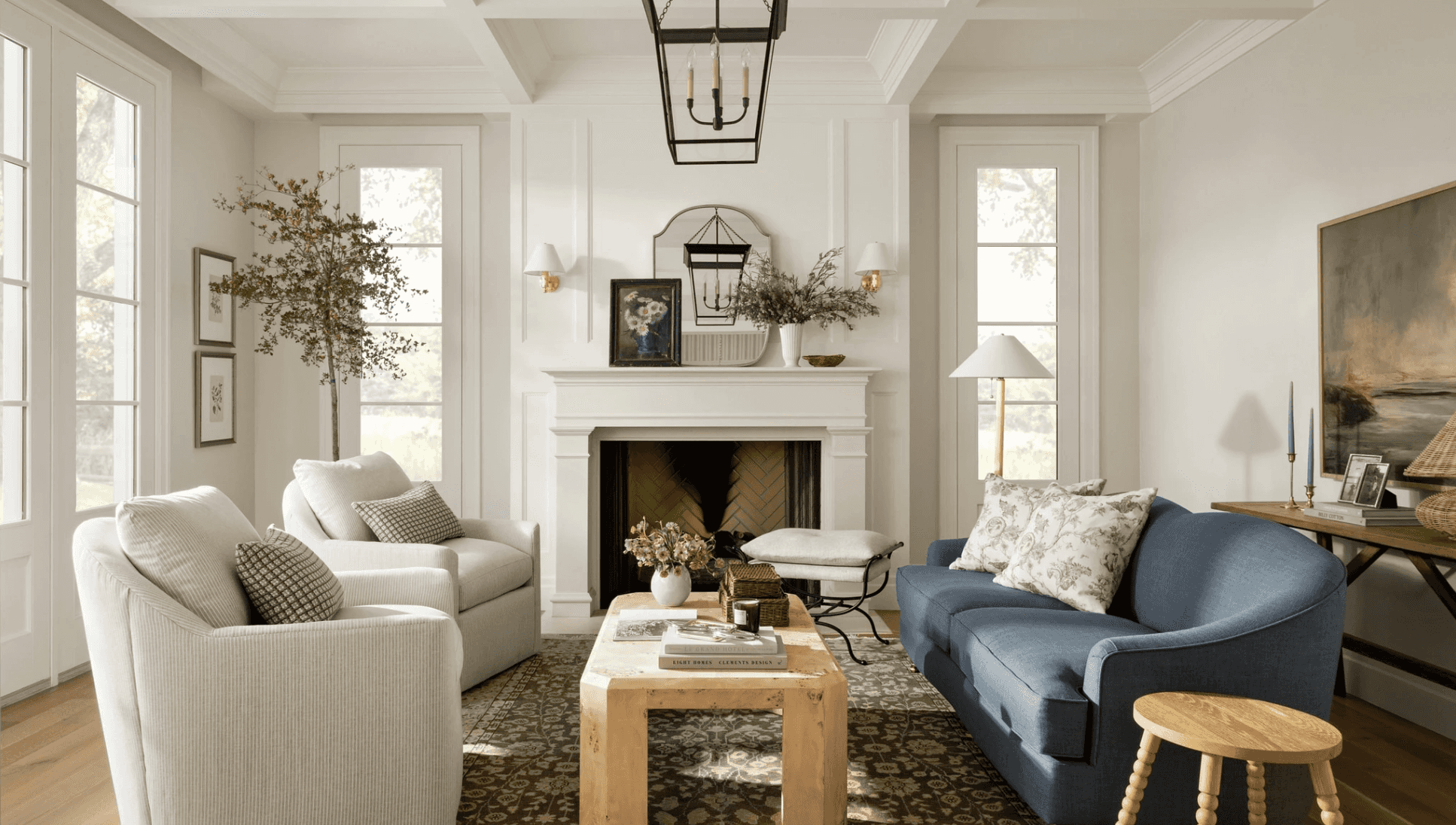 Cozy living room with white and blue sofas, fireplace, and coffee table.