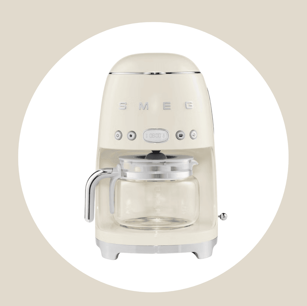 Cream-colored retro Smeg coffee maker with a glass carafe.