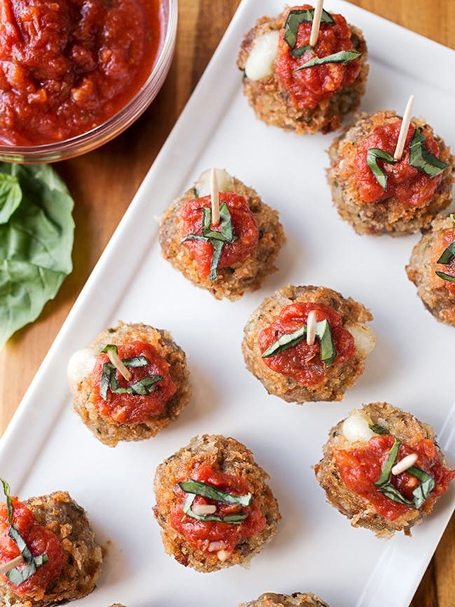 Crispy Caprese Meatballs Stuffed With Mozzarella on a white tray
