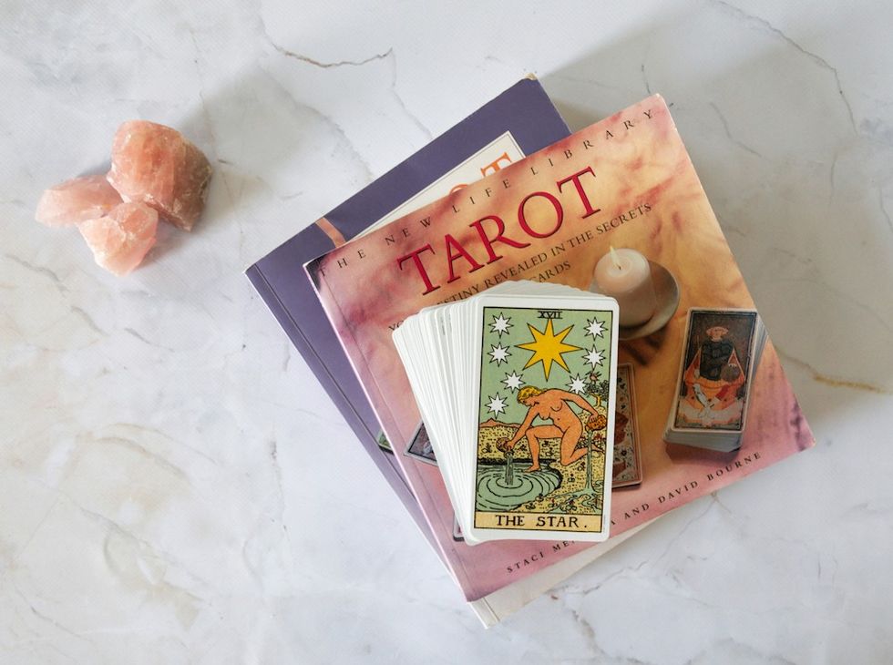 crystals next to a deck of tarot cards and a book about tarot cards