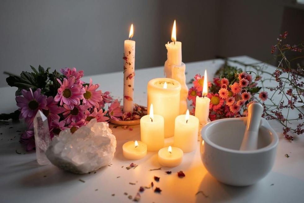 crystals next to candles and flowers